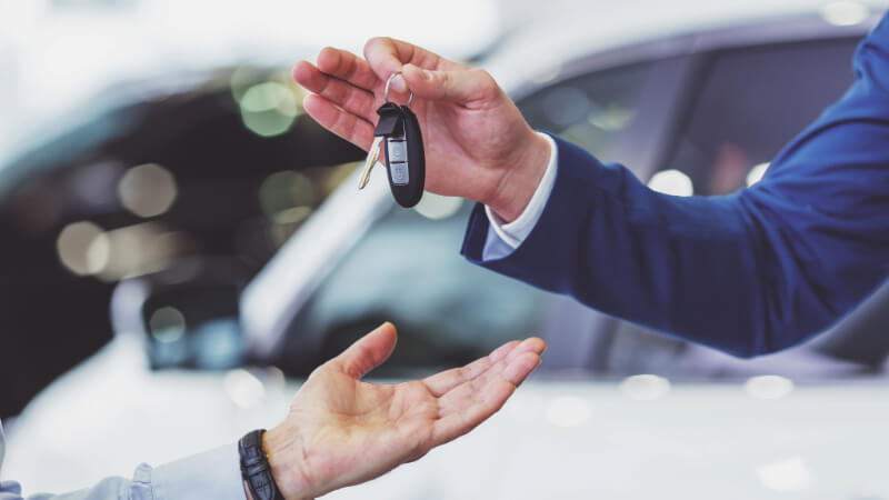 Photo of handing over a car dealership key